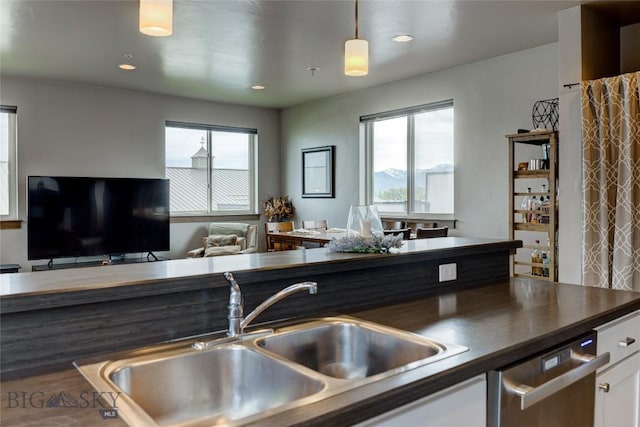 33 Intrepid Dr, Bozeman, MT 59718 - kitchen with a sink, dark countertops, open floor plan, white cabinets, and recessed lighting