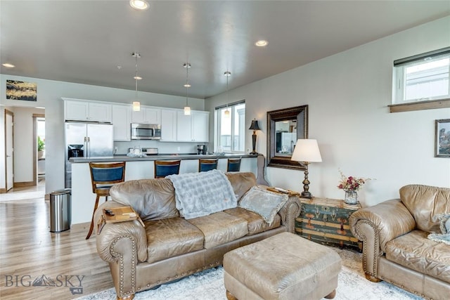 33 Intrepid Dr, Bozeman, MT 59718 - living area with healthy amount of natural light, light wood-style flooring, recessed lighting, and baseboards
