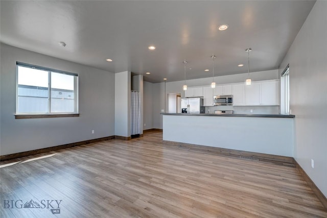 33 Intrepid Dr, Bozeman, MT 59718 - unfurnished living room with light wood finished floors and recessed lighting