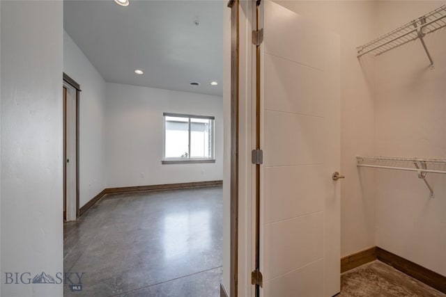 33 Intrepid Dr, Bozeman, MT 59718 - bathroom featuring concrete flooring, a spacious closet, and recessed lighting