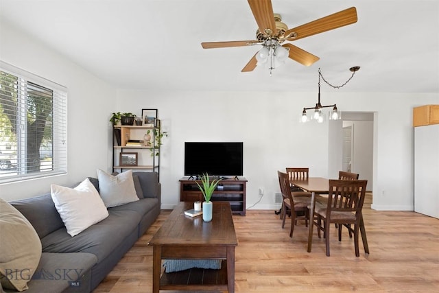 108 10th St Unit B, Belgrade, MT 59714 - living room featuring light wood-type flooring, a ceiling fan, and baseboards