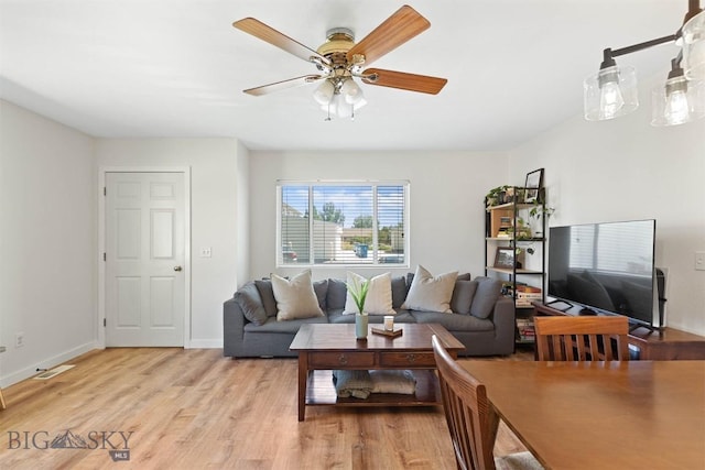 108 10th St Unit B, Belgrade, MT 59714 - living room featuring light wood finished floors, a ceiling fan, and baseboards