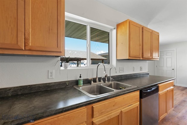 108 10th St Unit B, Belgrade, MT 59714 - kitchen featuring dishwasher, a sink, dark countertops, and wood finished floors