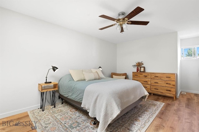 108 10th St Unit B, Belgrade, MT 59714 - bedroom featuring wood finished floors, baseboards, and a ceiling fan