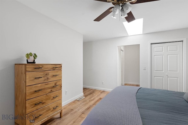 108 10th St Unit B, Belgrade, MT 59714 - bedroom with a skylight, light wood finished floors, baseboards, a ceiling fan, and a closet