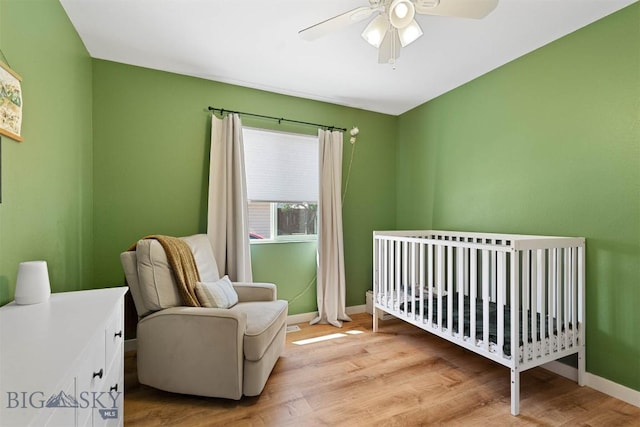 108 10th St Unit B, Belgrade, MT 59714 - bedroom featuring baseboards, light wood finished floors, a nursery area, and ceiling fan