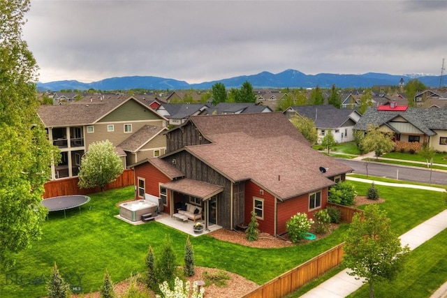 3493 Lolo Way, Bozeman, MT 59718 - back of house featuring a residential view, roof with shingles, a hot tub, a patio area, and a mountain view