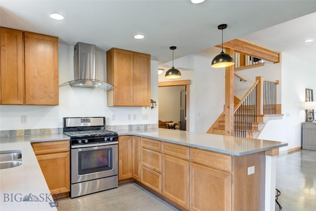 3493 Lolo Way, Bozeman, MT 59718 - kitchen featuring gas range, wall chimney range hood, a peninsula, light countertops, and hanging light fixtures