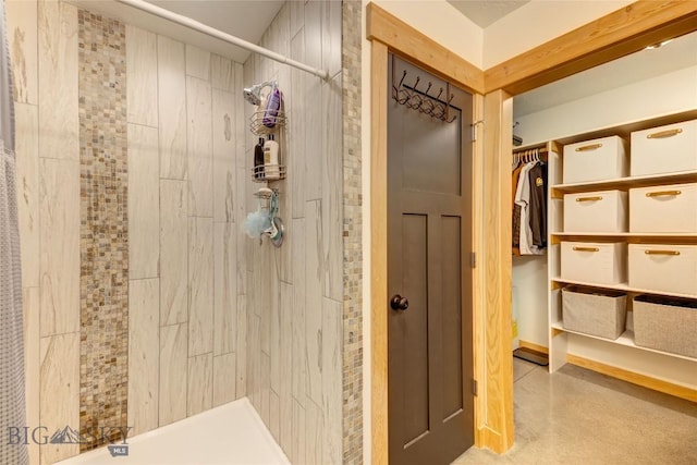 3493 Lolo Way, Bozeman, MT 59718 - bathroom featuring tiled shower and a spacious closet