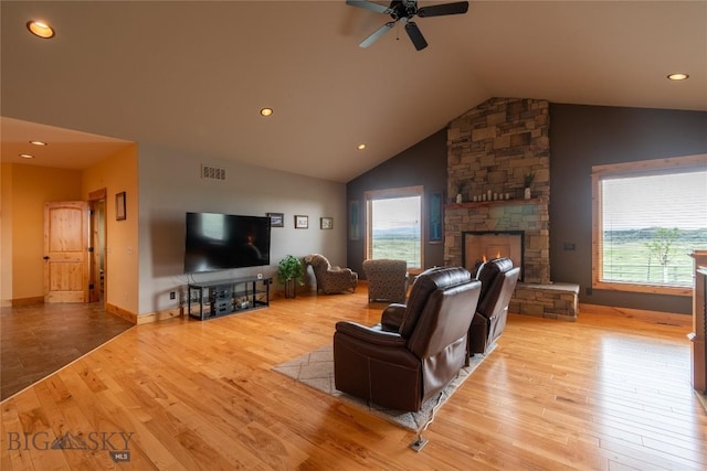115AND117 Otter Creek Rd, Big Timber, MT 59011 - living room featuring plenty of natural light, lofted ceiling, light wood-style flooring, a stone fireplace, and recessed lighting
