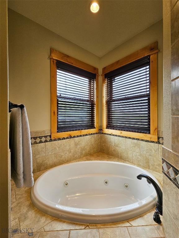115AND117 Otter Creek Rd, Big Timber, MT 59011 - full bathroom featuring a tub with jets and tile walls