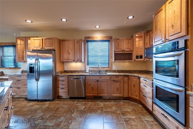 115AND117 Otter Creek Rd, Big Timber, MT 59011 - kitchen featuring appliances with stainless steel finishes, a sink, recessed lighting, glass insert cabinets, and stone counters
