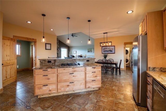 115AND117 Otter Creek Rd, Big Timber, MT 59011 - kitchen with estacked washer and dryer, stainless steel appliances, light brown cabinetry, light stone counters, and decorative light fixtures