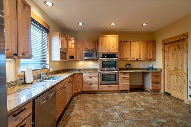 115AND117 Otter Creek Rd, Big Timber, MT 59011 - kitchen featuring appliances with stainless steel finishes, a sink, light stone countertops, recessed lighting, and glass insert cabinets