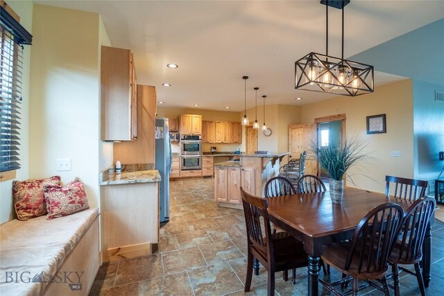 115AND117 Otter Creek Rd, Big Timber, MT 59011 - dining room with light stone finish flooring, recessed lighting, plenty of natural light, and a chandelier