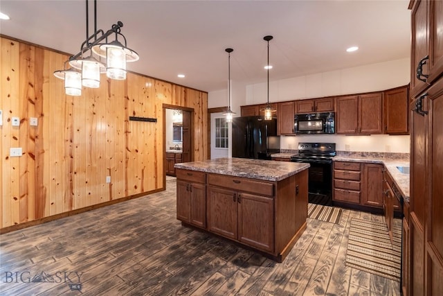 115AND117 Otter Creek Rd, Big Timber, MT 59011 - kitchen with black appliances, dark wood-style flooring, a kitchen island, wood walls, and hanging light fixtures