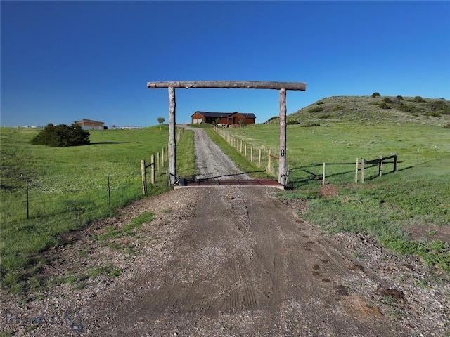 115AND117 Otter Creek Rd, Big Timber, MT 59011 - view of dirt / gravel driveway featuring a view of rural / pastoral area, a gated entry, and a gate