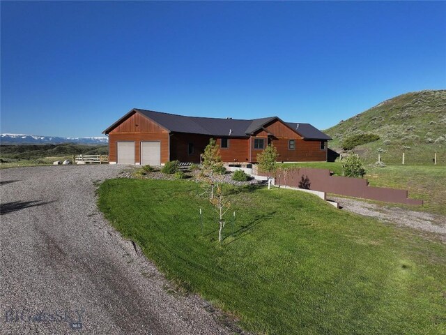 115AND117 Otter Creek Rd, Big Timber, MT 59011 - view of front facade featuring gravel driveway, a garage, a front yard, and a mountain view