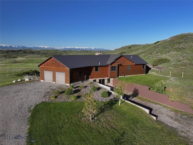 115AND117 Otter Creek Rd, Big Timber, MT 59011 - view of front of house with a mountain view, a garage, and gravel driveway