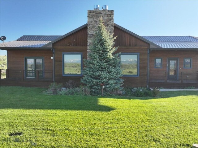 115AND117 Otter Creek Rd, Big Timber, MT 59011 - rear view of property with a lawn, a chimney, and metal roof