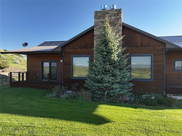 115AND117 Otter Creek Rd, Big Timber, MT 59011 - view of home's exterior with a lawn, metal roof, and a chimney
