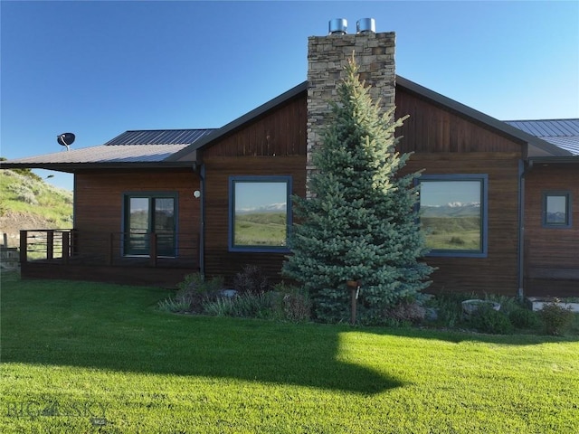 115AND117 Otter Creek Rd, Big Timber, MT 59011 - view of property exterior with a yard, metal roof, and a chimney