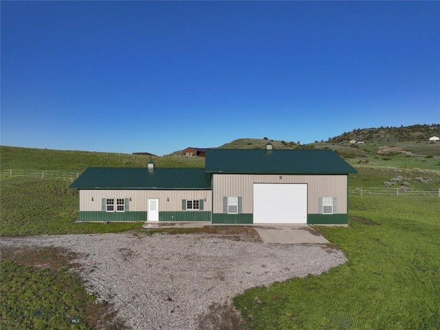 115AND117 Otter Creek Rd, Big Timber, MT 59011 - back of property with a chimney, metal roof, and gravel driveway
