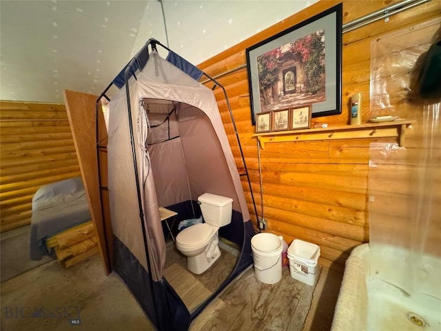 222 S Fork Ray Creek Rd, Townsend, MT 59644 - bathroom featuring log walls, toilet, and a bath