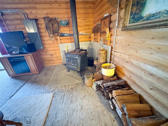 222 S Fork Ray Creek Rd, Townsend, MT 59644 - living area with log walls, a wood stove, and wood-type flooring
