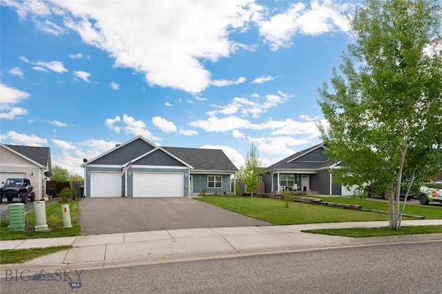 2206 Sturnella Ln, Belgrade, MT 59714 - view of front of property with an attached garage, driveway, a front lawn, and board and batten siding