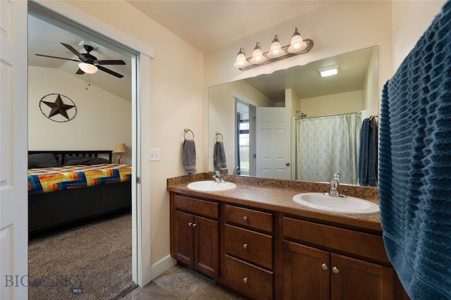 2206 Sturnella Ln, Belgrade, MT 59714 - ensuite bathroom featuring double vanity, ceiling fan, and vaulted ceiling