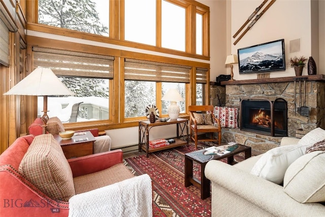 75 Rose Hip Cir, Big Sky, MT 59716 - living area featuring a fireplace, wood finished floors, and a towering ceiling
