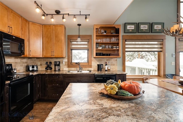 75 Rose Hip Cir, Big Sky, MT 59716 - kitchen featuring a sink, black appliances, decorative backsplash, and light stone counters