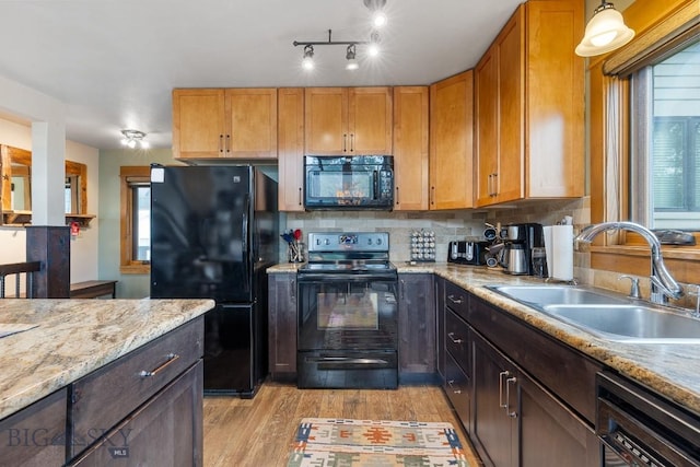 75 Rose Hip Cir, Big Sky, MT 59716 - kitchen with black appliances, light wood-type flooring, and tasteful backsplash