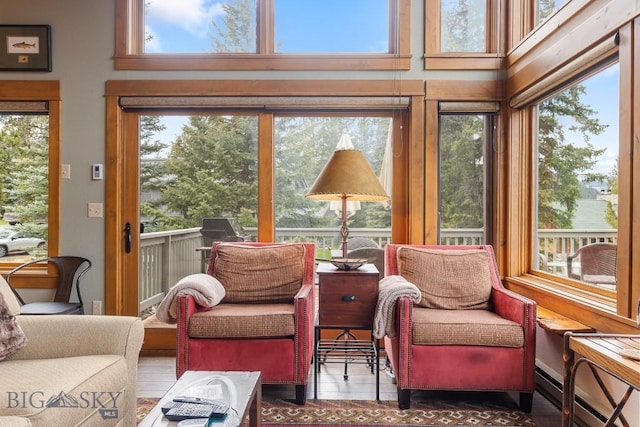 75 Rose Hip Cir, Big Sky, MT 59716 - sunroom / solarium featuring healthy amount of natural light, a high ceiling, and baseboard heating
