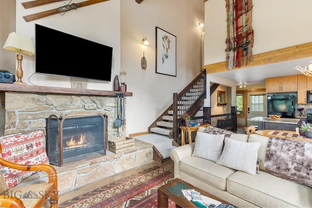 75 Rose Hip Cir, Big Sky, MT 59716 - living room with a fireplace, high vaulted ceiling, stairway, and beamed ceiling
