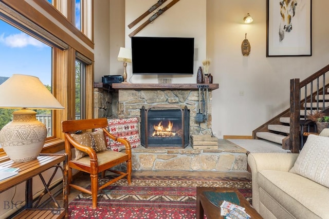 75 Rose Hip Cir, Big Sky, MT 59716 - living room featuring stairway, a stone fireplace, and a high ceiling