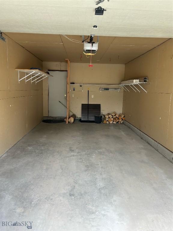 75 Rose Hip Cir, Big Sky, MT 59716 - garage featuring a garage door opener