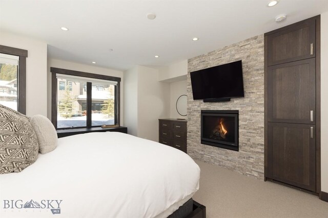 453 Outlook Trl, Big Sky, MT 59716 - bedroom with light carpet, recessed lighting, and a fireplace