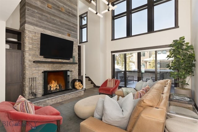 453 Outlook Trl, Big Sky, MT 59716 - living area featuring a towering ceiling, a fireplace, wood finished floors, and baseboards