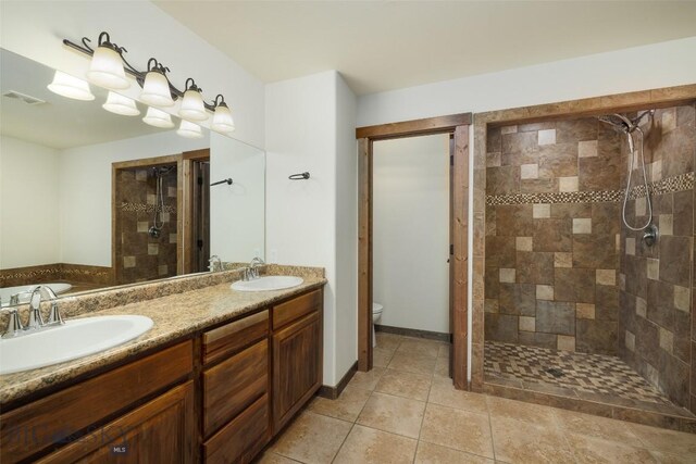 20 Prairie Grass B, Bozeman, MT 59718 - bathroom with tiled shower, double vanity, and tile patterned flooring