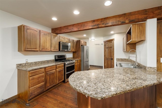 20 Prairie Grass B, Bozeman, MT 59718 - kitchen with stainless steel appliances, dark wood-style flooring, a peninsula, recessed lighting, and light stone countertops