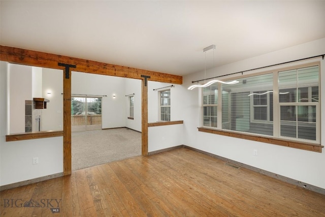 20 Prairie Grass B, Bozeman, MT 59718 - unfurnished room featuring wood finished floors and a barn door