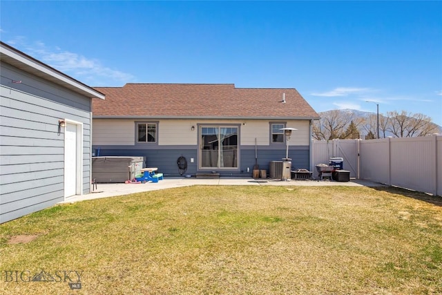 3135 Mantle, Butte, MT 59701 - back of house with a patio area, cooling unit, a covered hot tub, and a mountain view