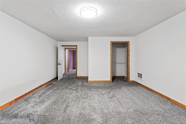 3135 Mantle, Butte, MT 59701 - unfurnished bedroom with carpet floors, baseboards, a closet, and a textured ceiling