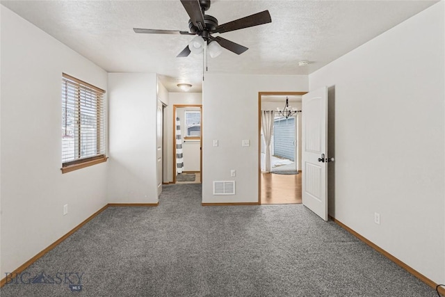 3135 Mantle, Butte, MT 59701 - unfurnished bedroom featuring baseboards, carpet floors, a textured ceiling, a chandelier, and ceiling fan