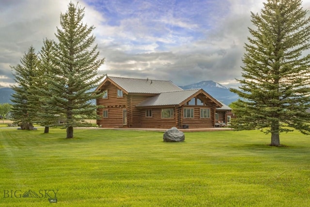 3 Dolly Varden Dr, Mcallister, MT 59740 - view of front of house featuring log siding, a front lawn, a mountain view, metal roof, and a standing seam roof