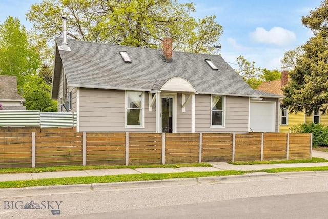 209 N 3rd, Bozeman, MT 59715 - view of front of property with a fenced front yard, a chimney, a shingled roof, and a garage
