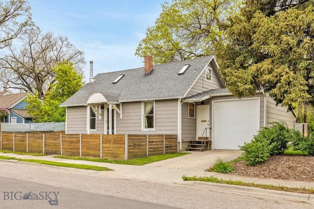 209 N 3rd, Bozeman, MT 59715 - view of front of home featuring an attached garage, driveway, a fenced front yard, a shingled roof, and a chimney