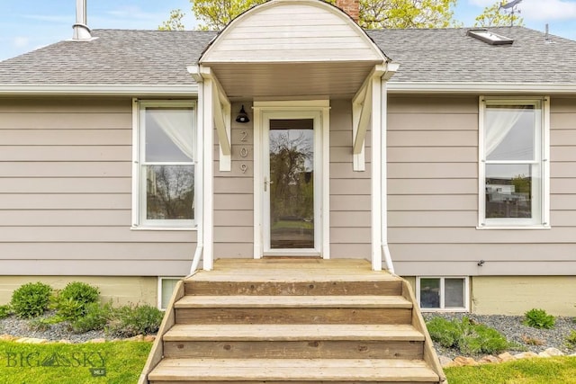 209 N 3rd, Bozeman, MT 59715 - view of exterior entry with a shingled roof and a chimney